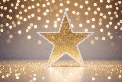 The primary subject of the image is a gold star, which is the main object, scene, or focus of the image. The setting/background features a white surface, and the visual style is a photo. The colors and mood of the image are predominantly gold and warm, creating a festive and celebratory atmosphere.